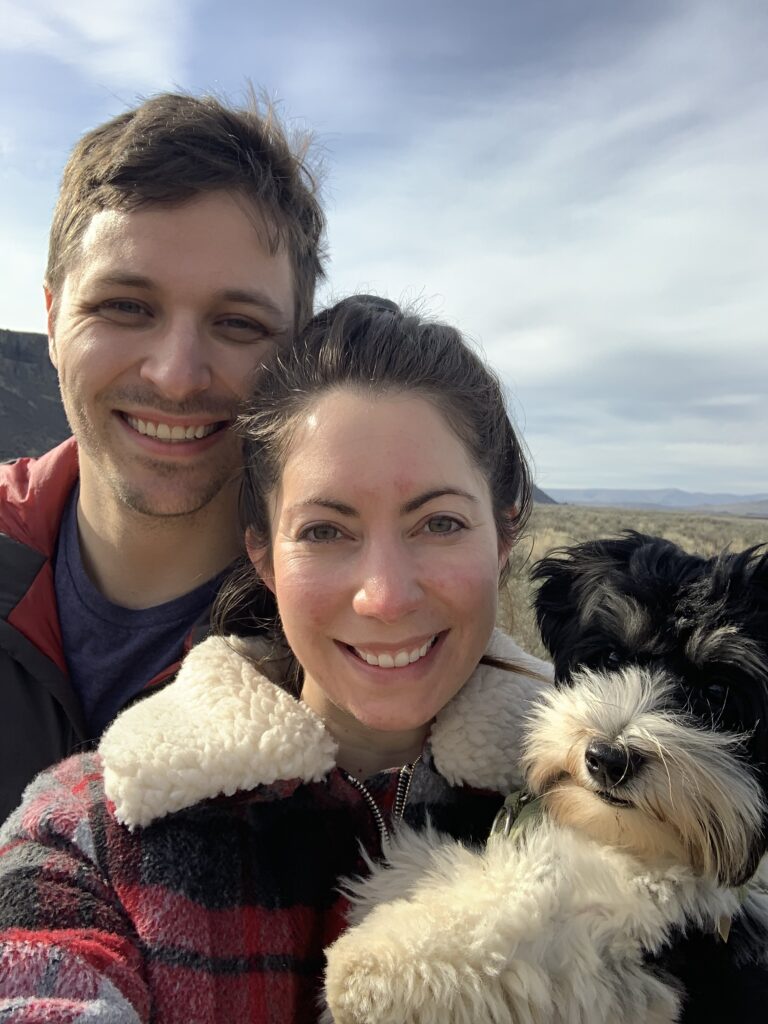 Couple with biewer terrier dog hiking in PNW Quincy WA at the Sagecliffe mountains