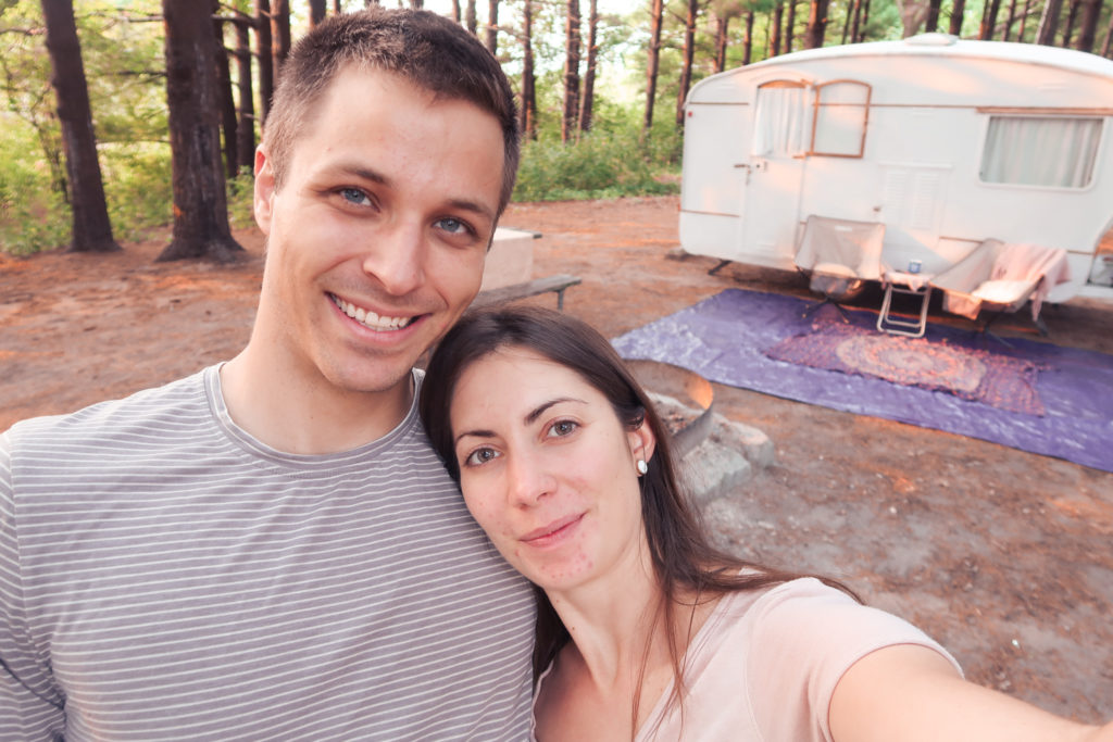 couple camping in illinois state beach park with vintage camper
