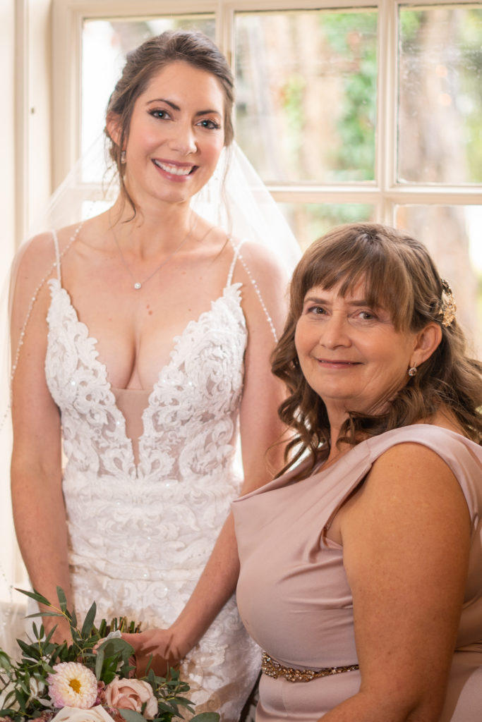 Mother and daughter in wedding dress sitting on piano at small wedding elopement at Colonial Williamsburg Inn
